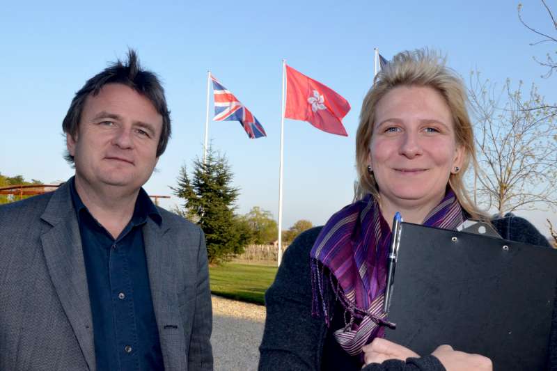 Stephen and Jo outside Pontet Canet with the British and Hong Kong flags fluttering over the vineyard.
