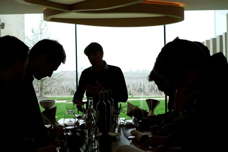 The team taste Cheval Blanc 2018 with the vineyard in the background