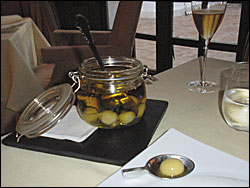 A jar of green olives that one is instructed to eat all in one go as they are in fact composed of olive oil that dissolves once in the mouth.